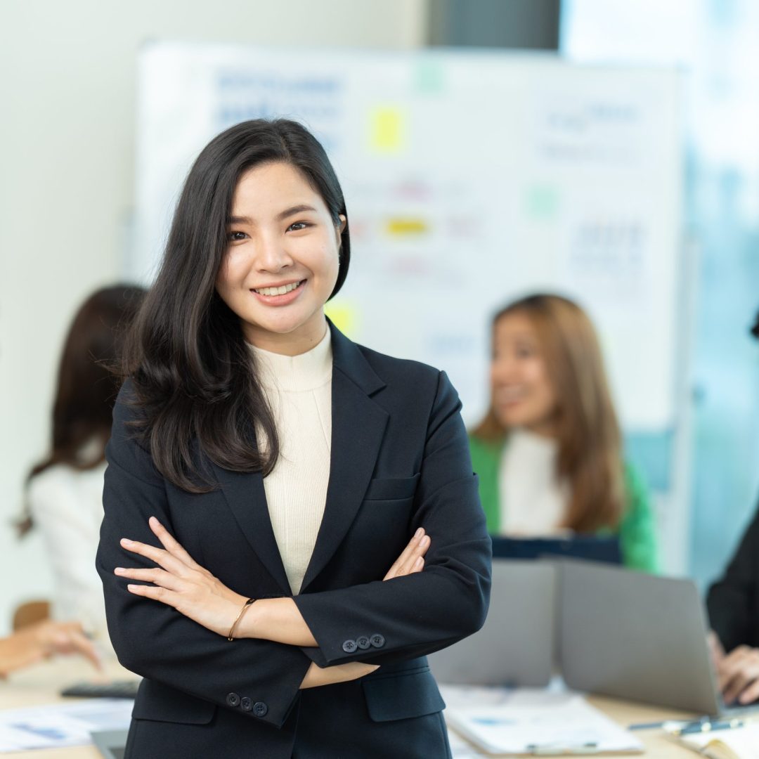 Business people showing team work while working in board room in office interior. People helping one of their colleague to finish new business plan. Business concept. Team work.